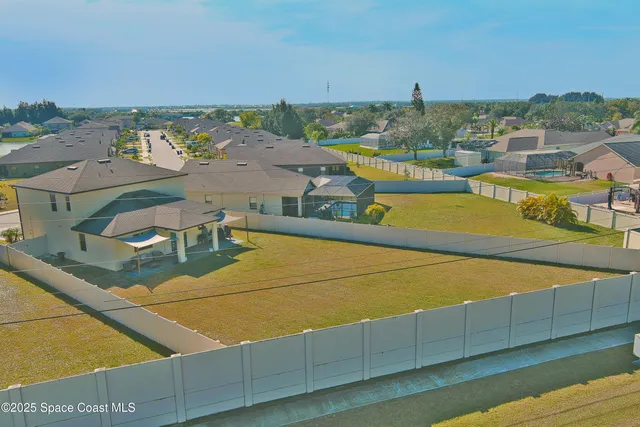 an aerial view of a house with a swimming pool