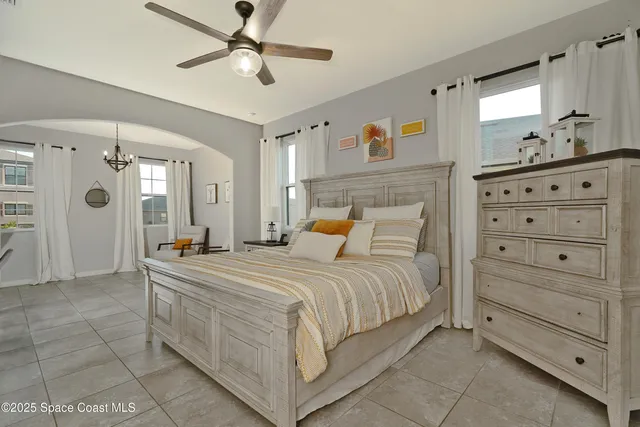 a bedroom with a bed and a chandelier