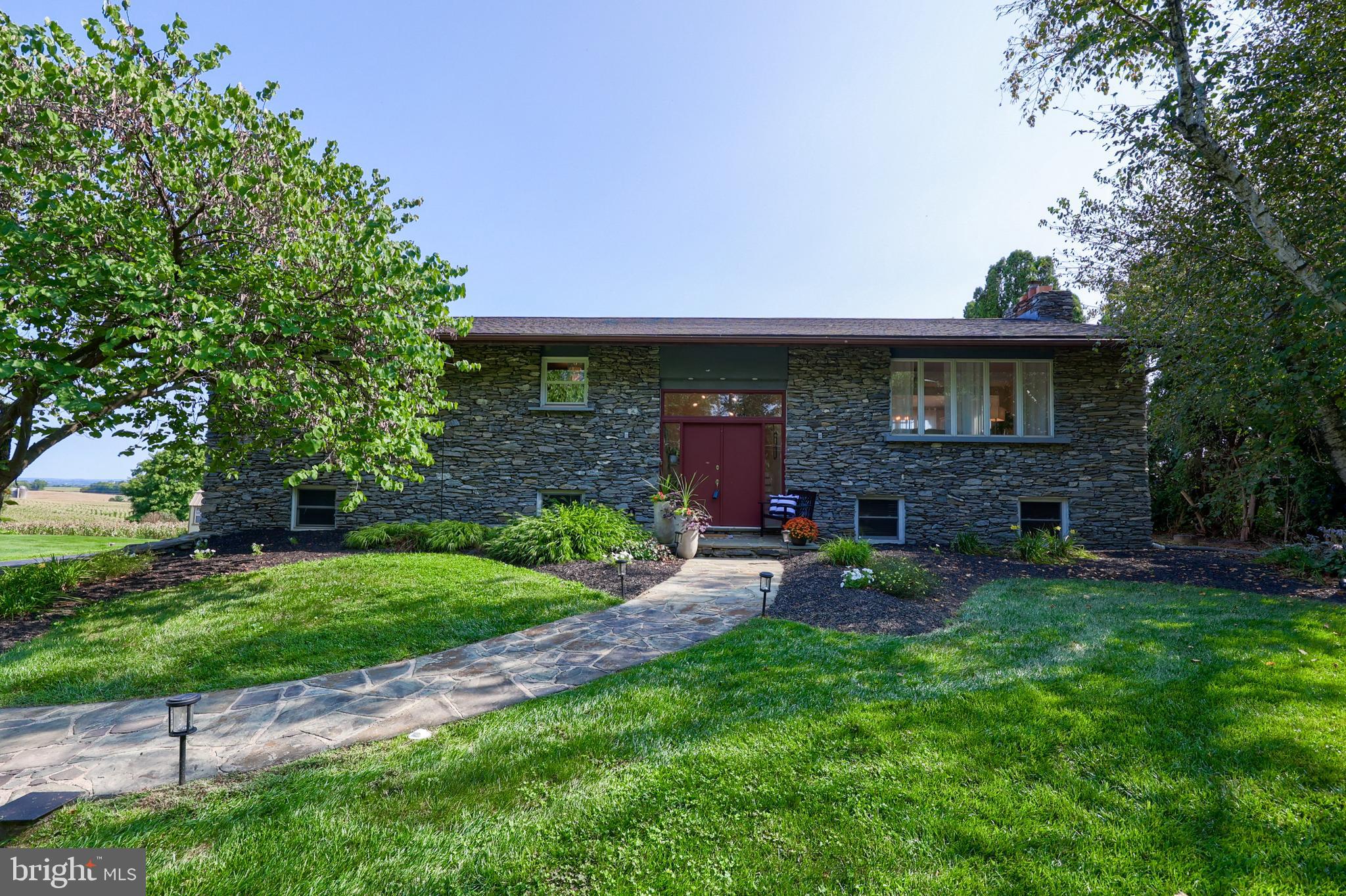 670 Shultz Road Washington Boro, PA 17582 - Photo 1 of 79 a view of a brick house with a yard and large tree