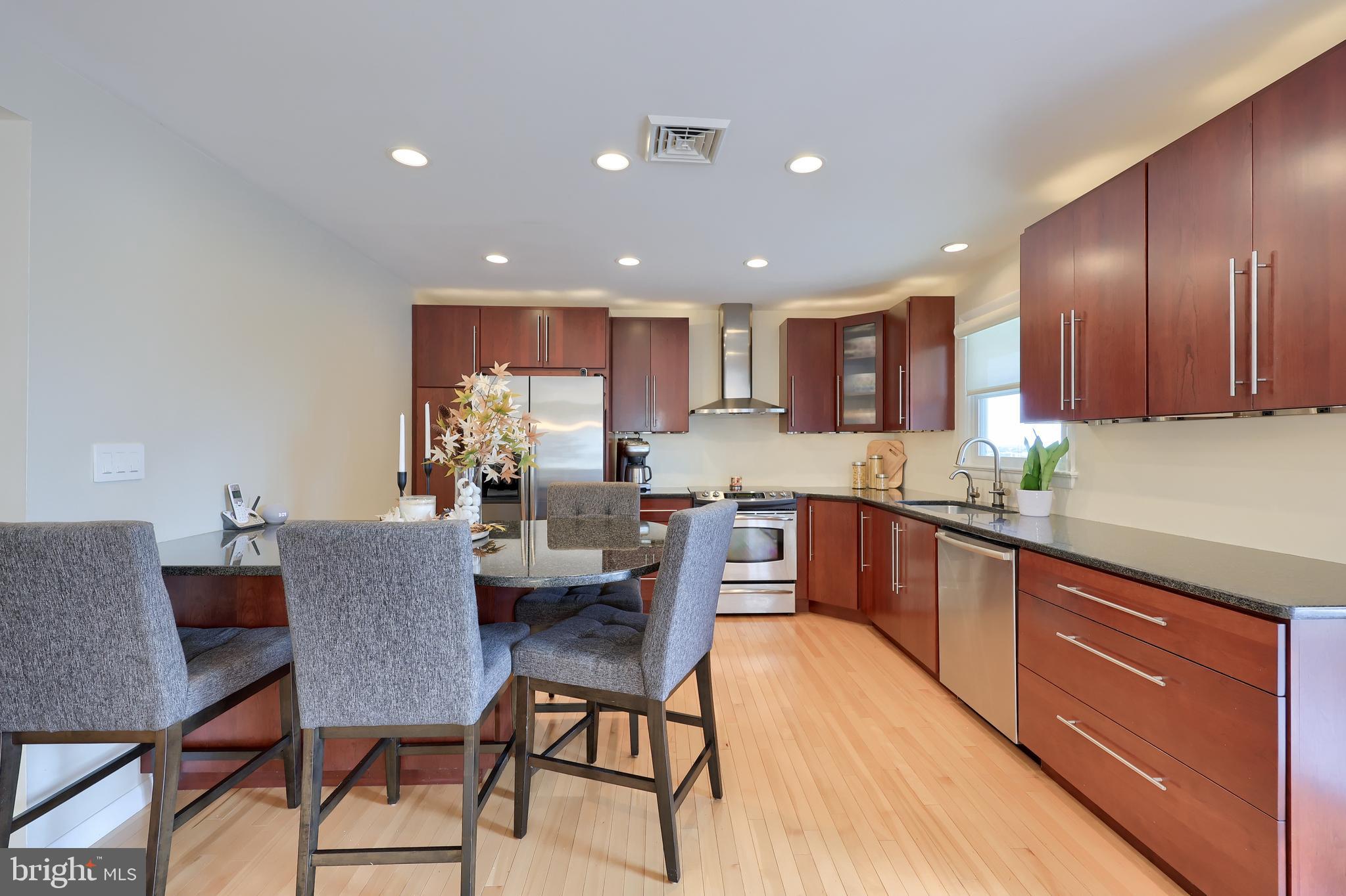 670 Shultz Road Washington Boro, PA 17582 - Photo 11 of 79 a kitchen with a dining table chairs and wooden cabinets