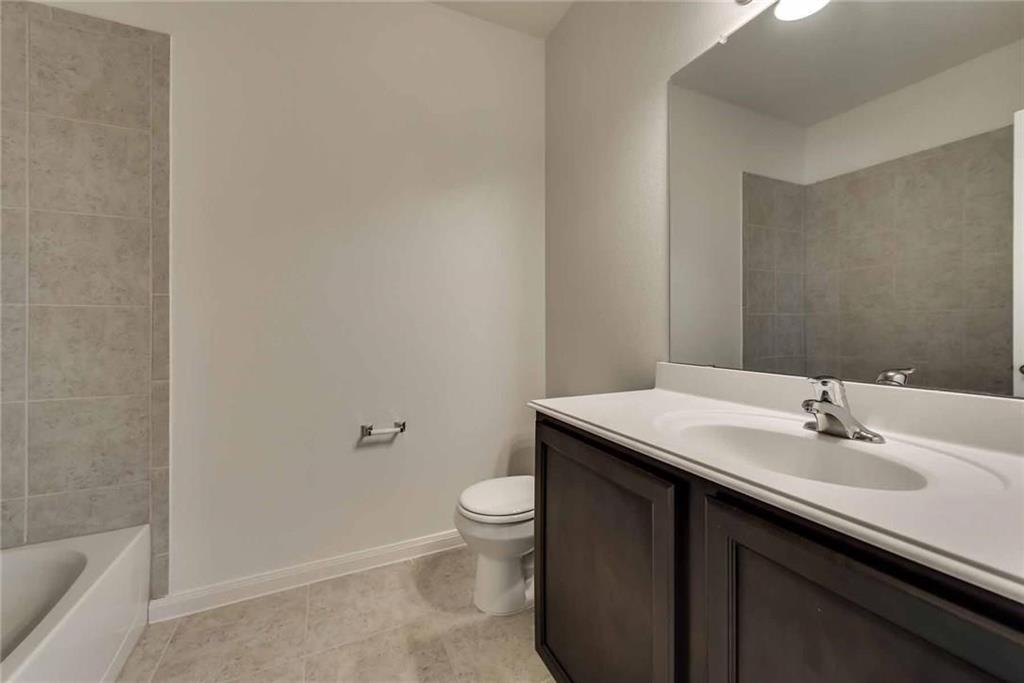 4720 Merchant Trail Denton, TX 76207 - Photo 12 of 13 a bathroom with a sink a toilet and shower
