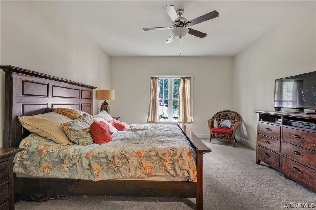 4112 Hidden Valley Road Chester, VA 23831 - Photo 13 of 29 a bedroom with a bed a chandelier and dresser