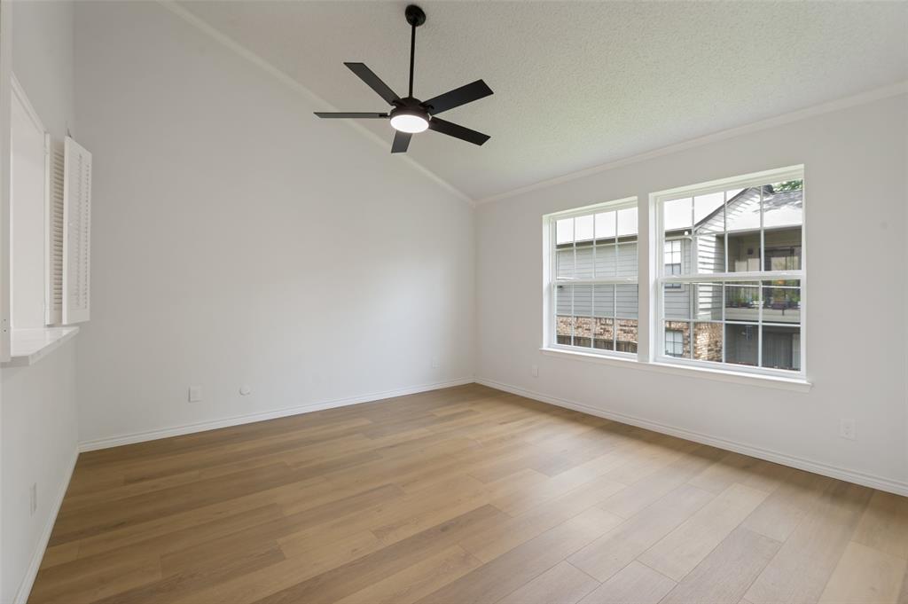 5300 Keller Springs Road, Unit 2042 Dallas, TX 75248 - Photo 4 of 28 Spacious interior featuring a vaulted ceiling, wood-finish flooring, and a modern ceiling fan