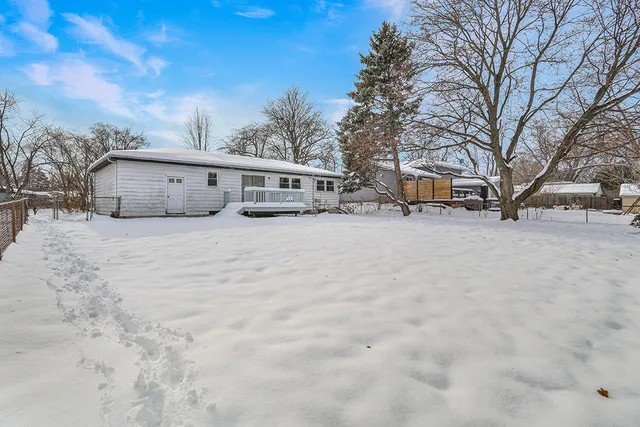 a view of a house with a snow in the yard