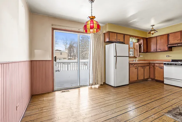 a kitchen that has a refrigerator and a stove