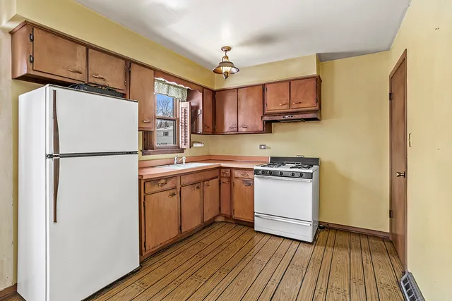 a kitchen with stainless steel appliances granite countertop a refrigerator stove a sink and dishwasher