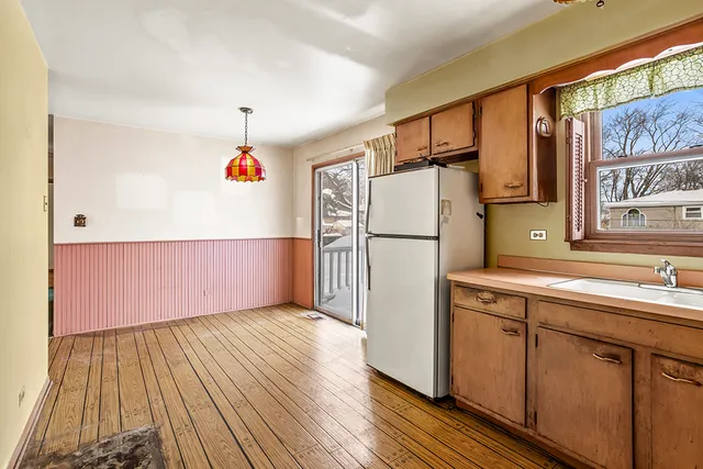 a kitchen with a refrigerator and a sink