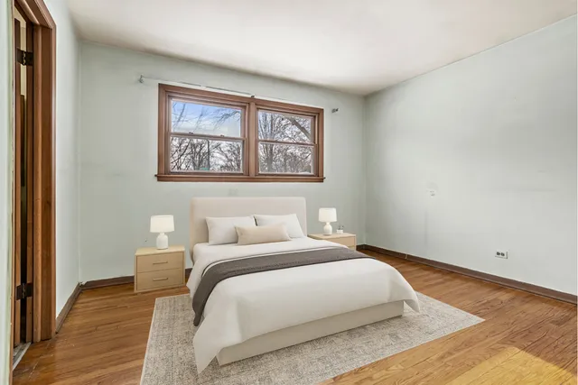 a bedroom with a bed and a painting on the wall