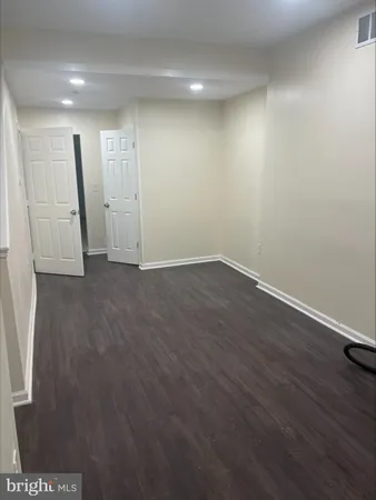an empty room with wooden floor