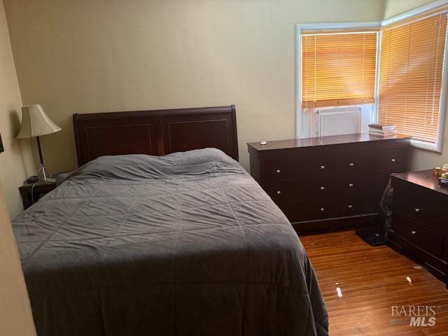 618 Benton Street Santa Rosa, CA 95404 - Photo 8 of 27 a bedroom with a bed and wooden floor