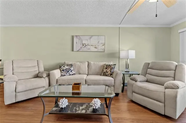 a living room with furniture and kitchen view