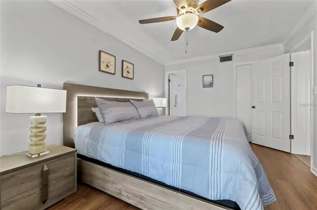 a bedroom with a large bed and a chandelier