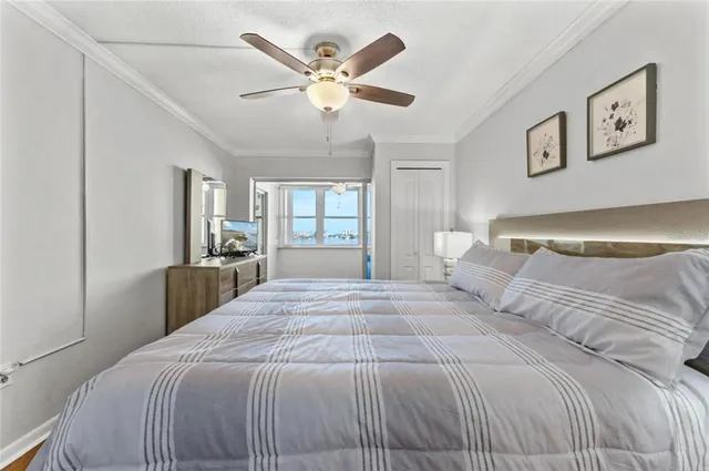 a bedroom with a bed and a night stand