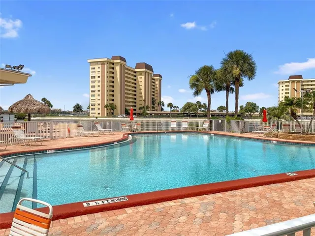 a view of a swimming pool with a lawn chairs