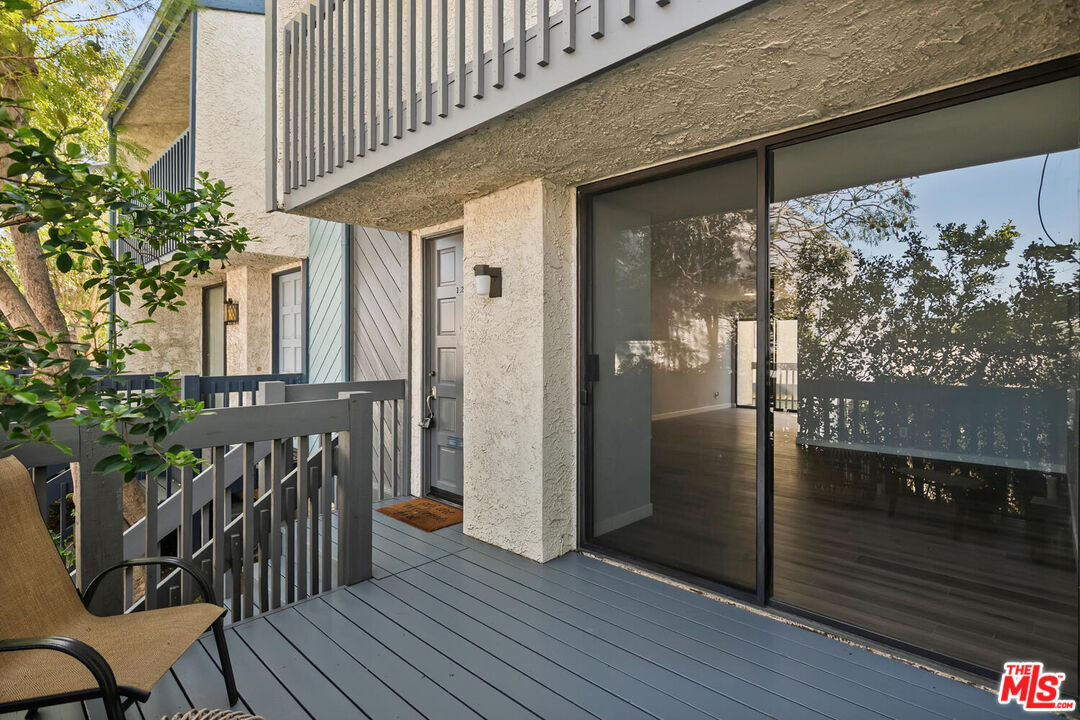 29239 Heathercliff Road, Unit 12 Malibu, CA 90265 - Photo 4 of 32 a view of a porch with wooden floor