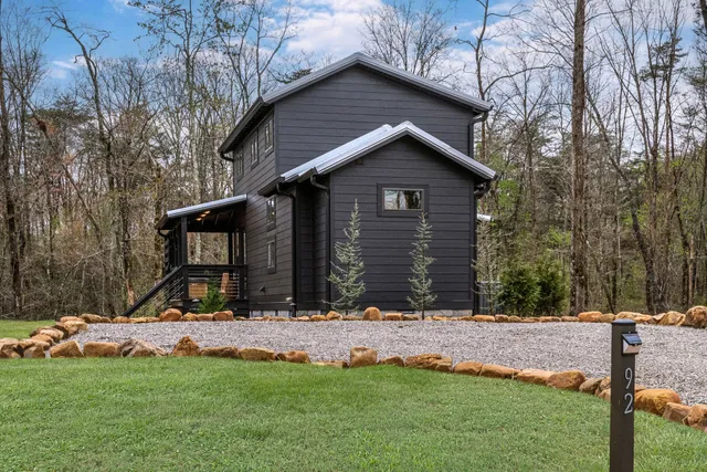 a view of a house with a yard covered in snow