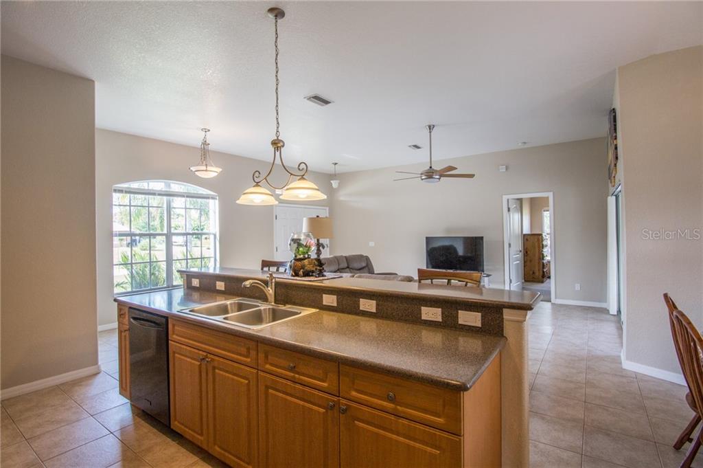 Looking from kitchen over the living room, front door to left, master bedroom door straight ahead