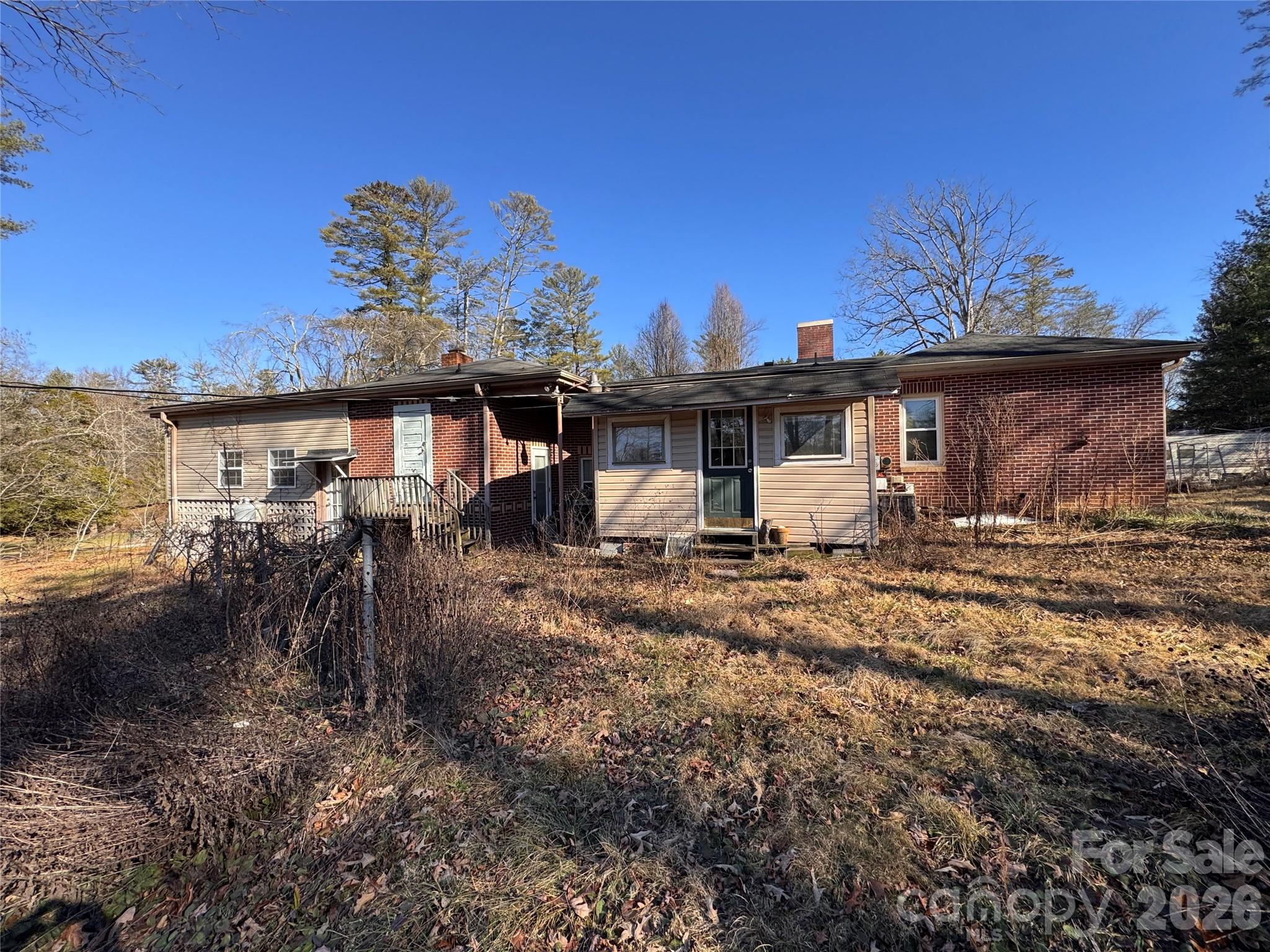 2409 Kanuga Road Hendersonville, NC 28739 - Photo 7 of 7 a view of a house with backyard and sitting area
