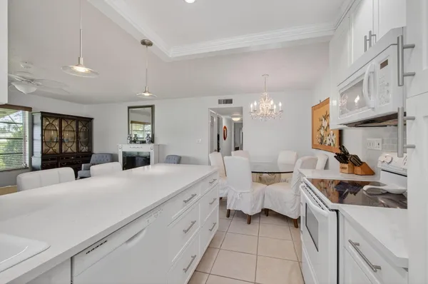 a large white bathroom with a granite countertop sink mirror and a bathtub