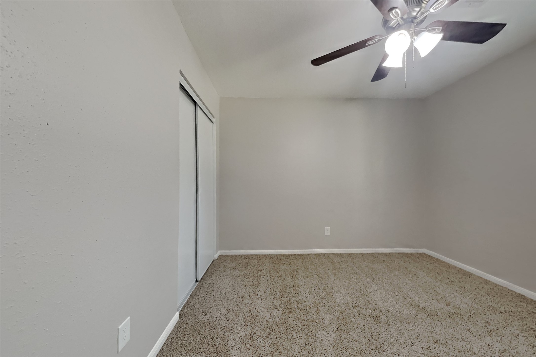 514 Rams Bottom Court Spring, TX 77388 - Photo 14 of 19 an empty room with a chandelier fan and closet area