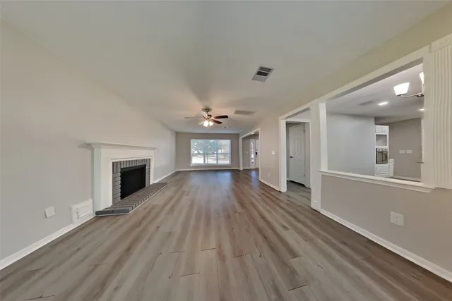 wooden floor in an empty room with a fireplace