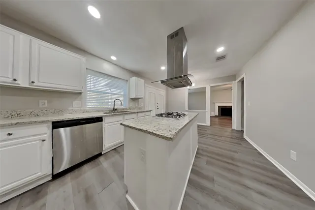 a kitchen with stainless steel appliances granite countertop a sink and a stove top oven