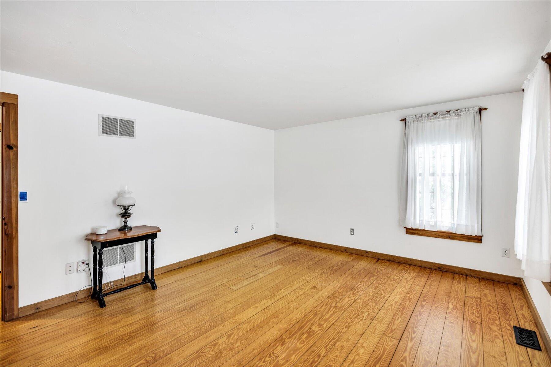 85 Clamshell Cove Road Cotuit, MA 02635 - Photo 22 of 46 a view of an empty room with wooden floor and a window