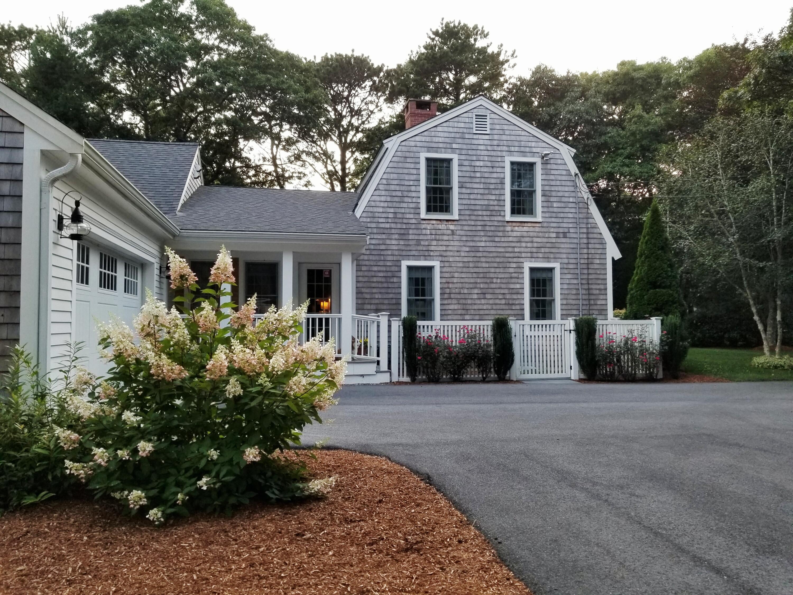 85 Clamshell Cove Road Cotuit, MA 02635 - Photo 28 of 46 a front view of a house with garden
