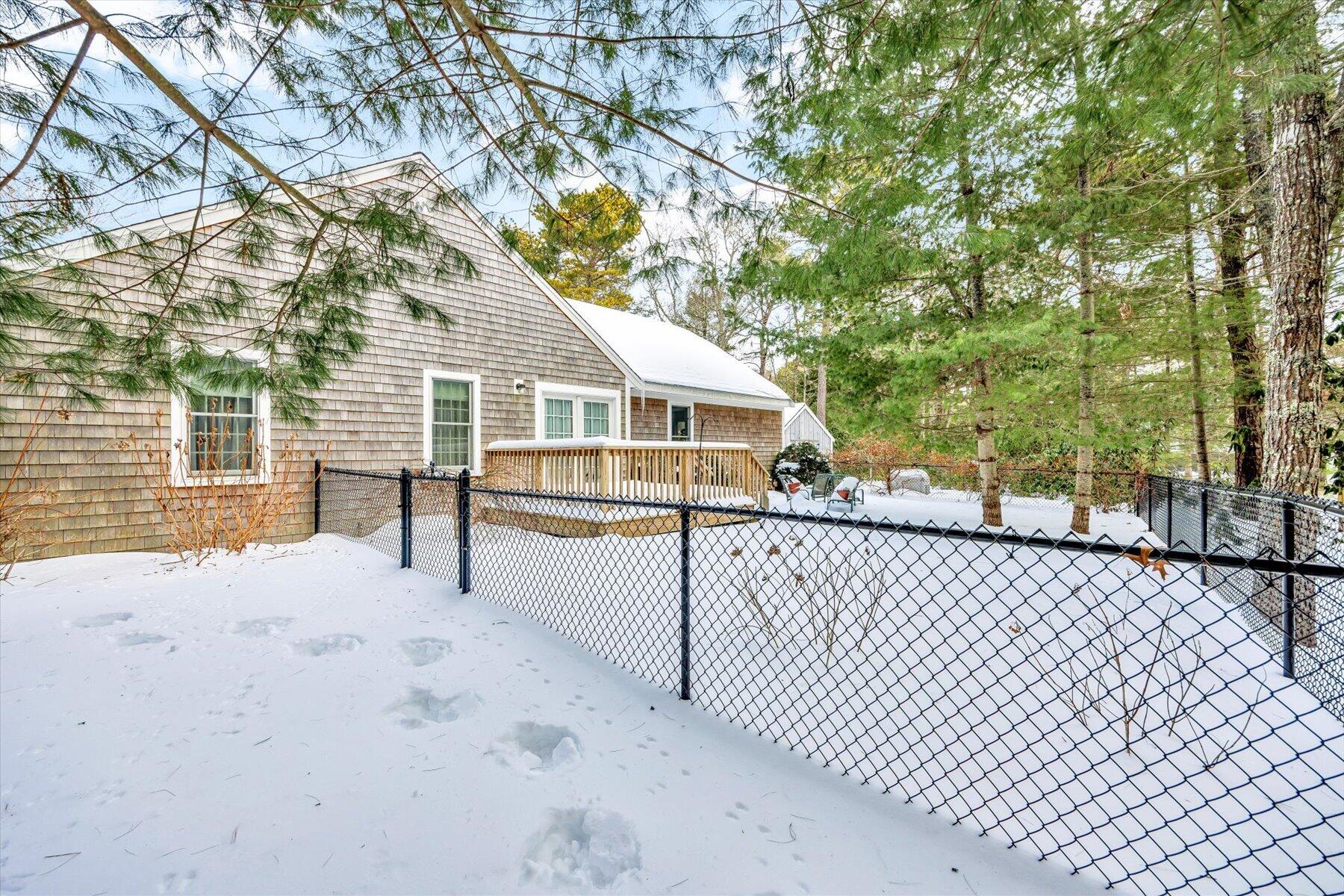 85 Clamshell Cove Road Cotuit, MA 02635 - Photo 41 of 46 a view of house with wooden fence and a trees