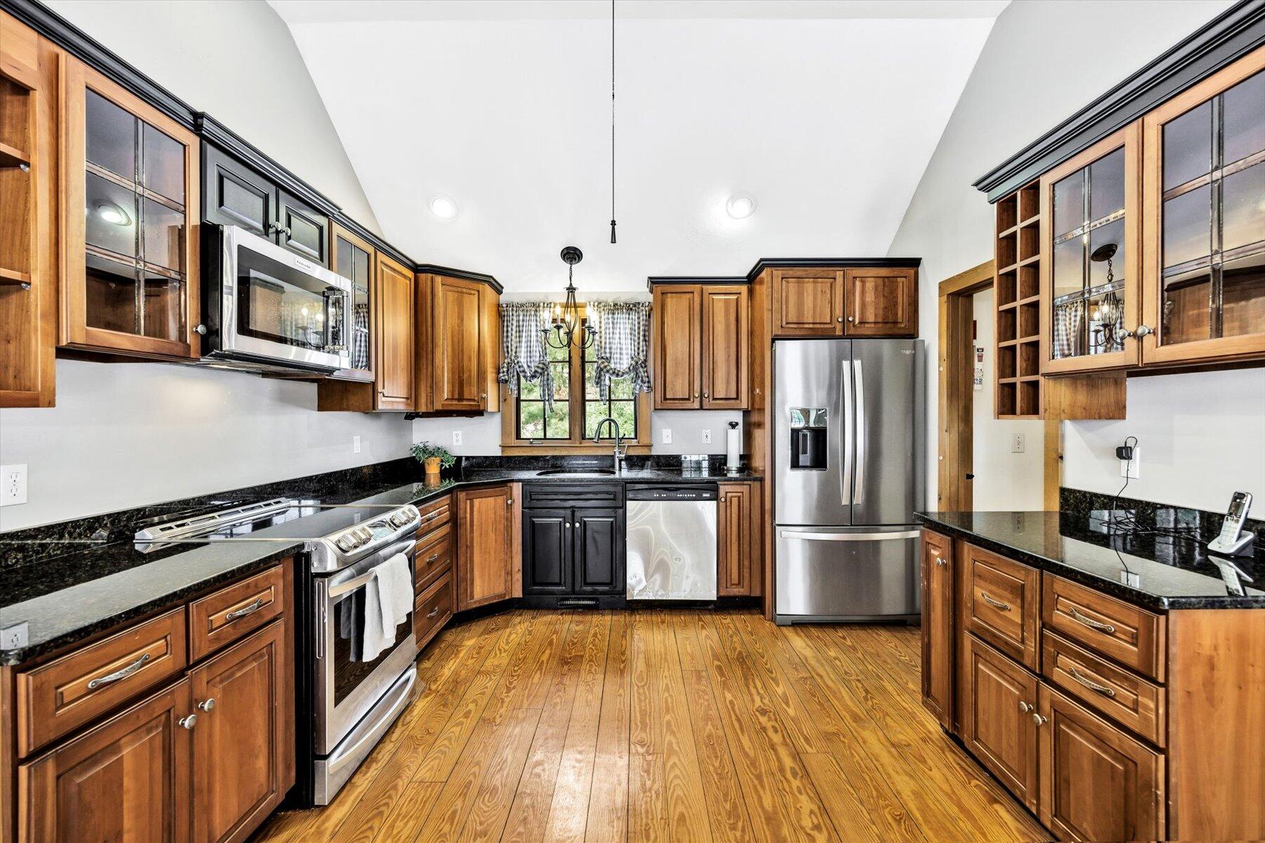 85 Clamshell Cove Road Cotuit, MA 02635 - Photo 7 of 46 a kitchen with stainless steel appliances granite countertop a refrigerator a stove and a wooden floors