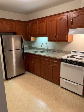 29 Leo's Lane Avon, MA 02322 - Photo 2 of 8 a kitchen with granite countertop stainless steel appliances a refrigerator a sink a stove a washer and dryer