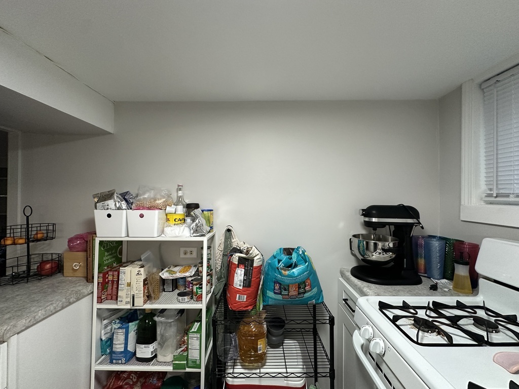 5701 North Keystone Avenue, Unit GDN Chicago, IL 60646 - Photo 8 of 20 a kitchen with a stove and wooden floor