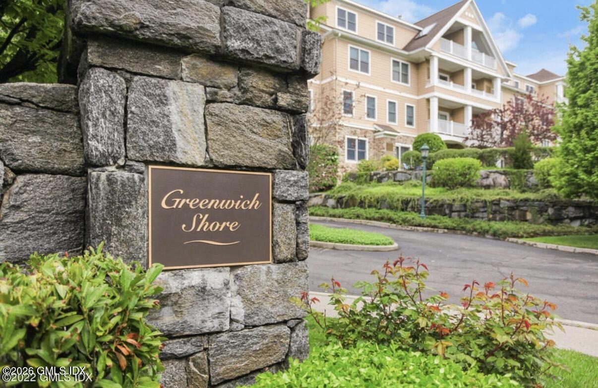 124 Ritch Avenue, Unit B301 Greenwich, CT 06830 - Photo 2 of 7 a sign broad in front of flowers