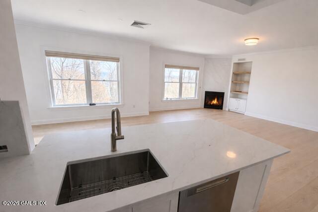124 Ritch Avenue, Unit B301 Greenwich, CT 06830 - Photo 5 of 7 a kitchen with stainless steel appliances a sink a stove and white cabinets