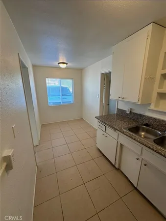 a kitchen with stainless steel appliances a sink stove and cabinets