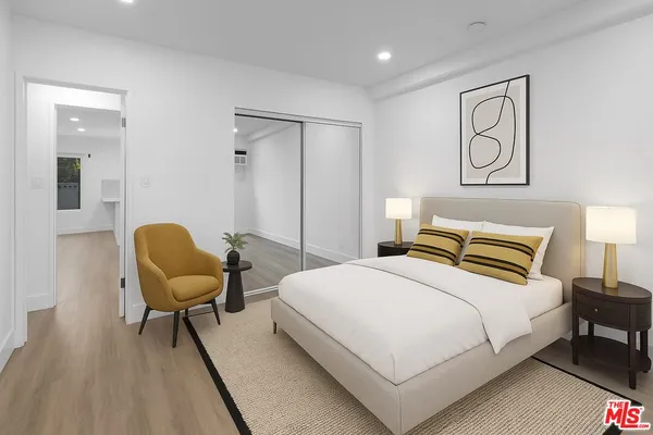 a bedroom with a bed and chair