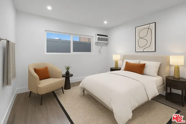 a bedroom with a bed and glass window
