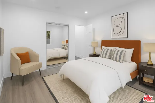 a bedroom with bed and window