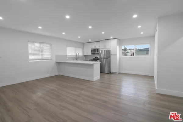 a view of kitchen with wooden floor and window