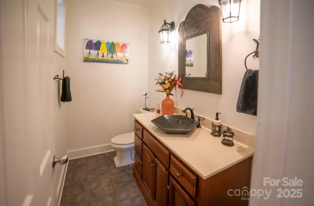 a bathroom with a sink a toilet and mirror
