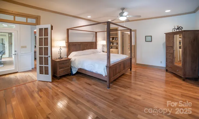 a bedroom with a bed closet and a mirror