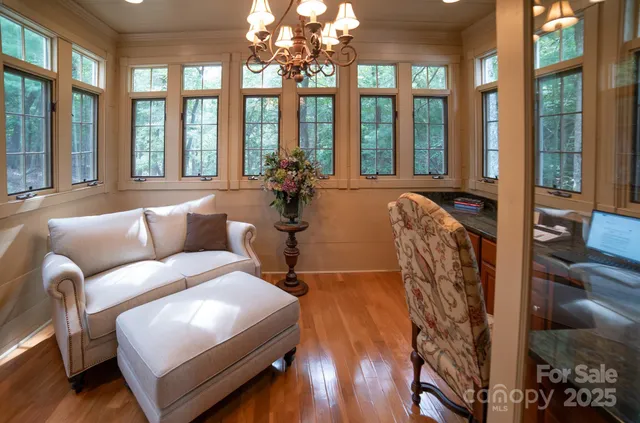 a living room with furniture and large windows