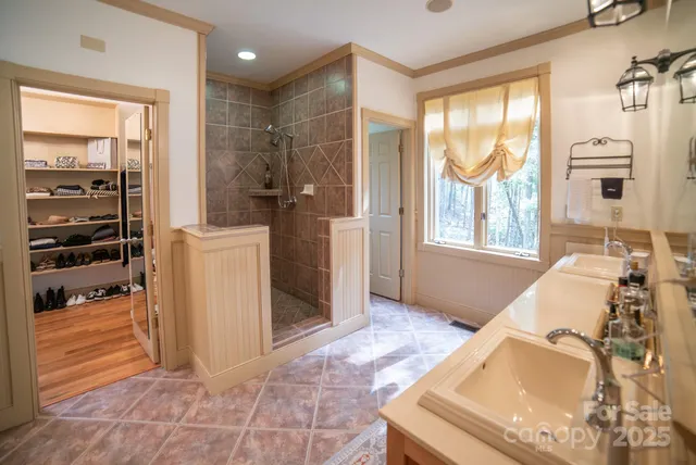 a view of a bathroom with tub and windows