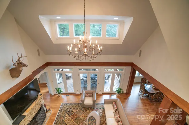 a living room with furniture and a chandelier