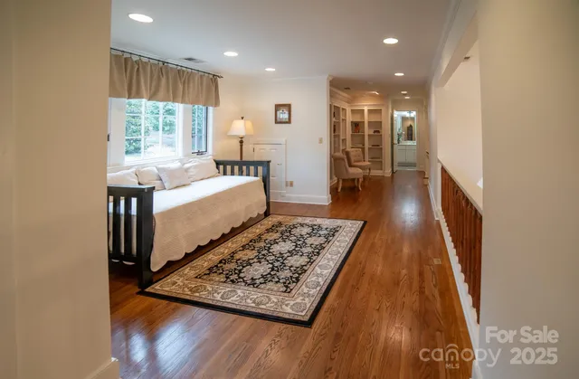 a living room with wooden floor furniture and a large window