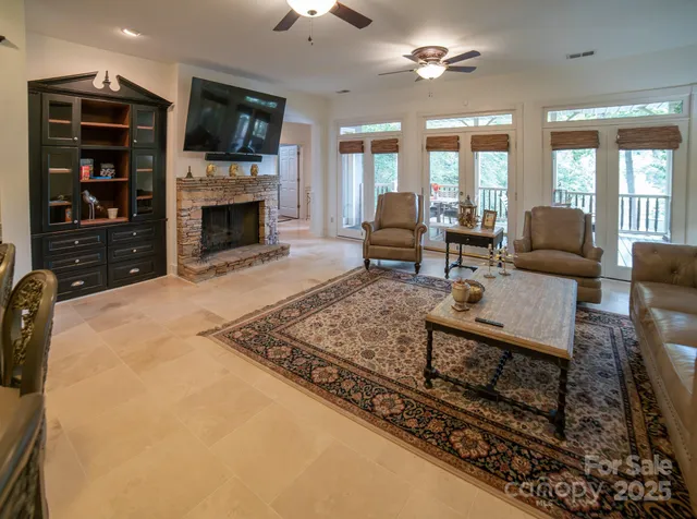 a living room with furniture a fireplace and a flat screen tv