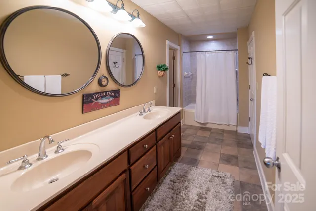 a bathroom with a double vanity sink and a mirror