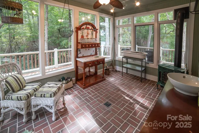 a living room with furniture a rug and a floor to ceiling window