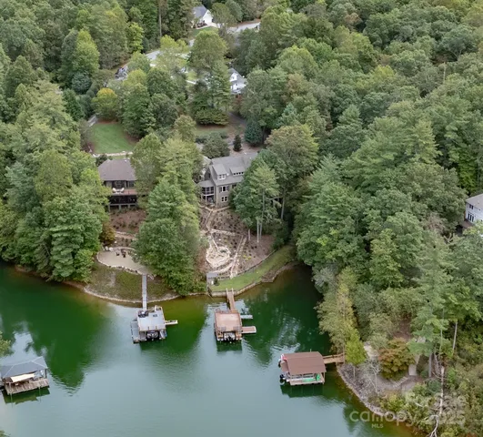 an aerial view of a house with a yard basket ball court and outdoor seating