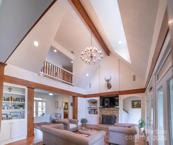 a living room with fireplace furniture and a large window